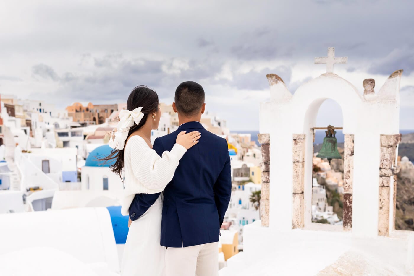 Picturesque rooftop engagement photography in Santorini, Greece, captured by NYC Wedding Photographer, Kiss Me in New York.