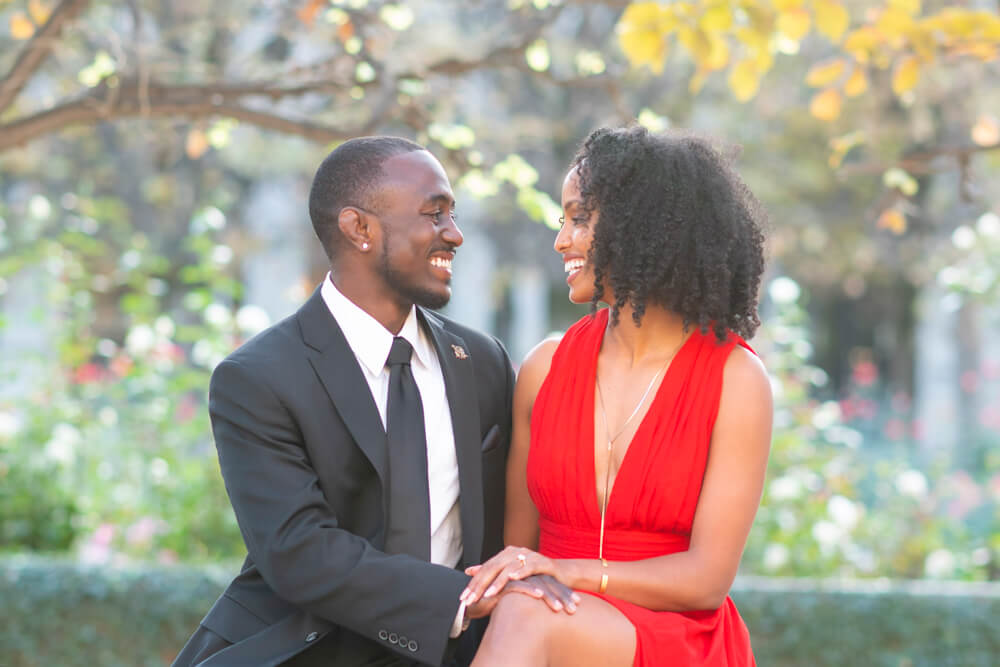 During their engagement session, the couple shared a romantic moment on a bench in a lush New York City park.