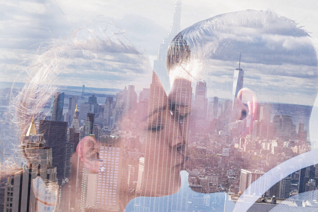 Creative double exposure NYC Engagement Photo with the Manhattan skyline as an iconic backdrop.