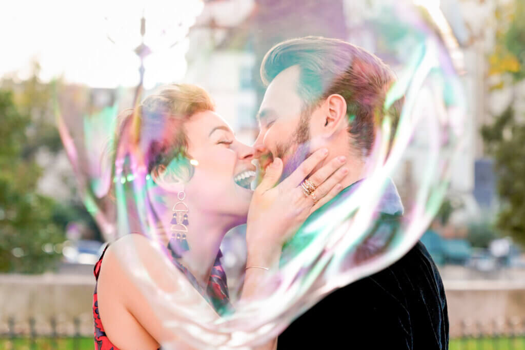 Super cute NYC engagement love story in Central Park with a couple blissfully connecting within a massive bubble.