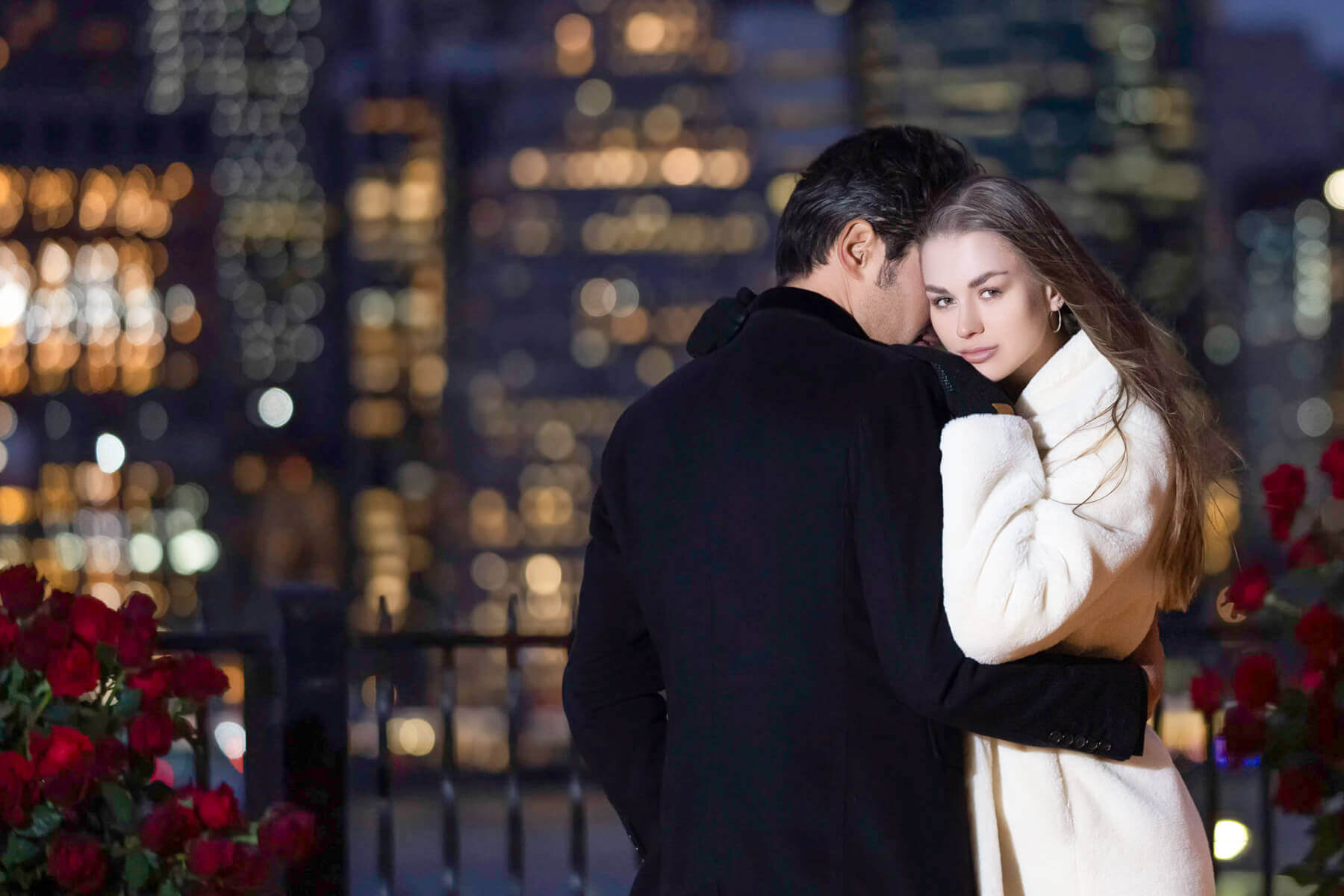 Stunning couple embracing for their engagement photos in NYC, captured moments after getting engaged.